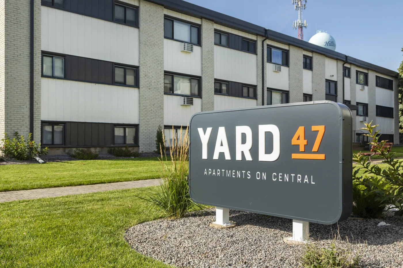 Yard 47 — monument sign reading Apartments on Central in front of the building